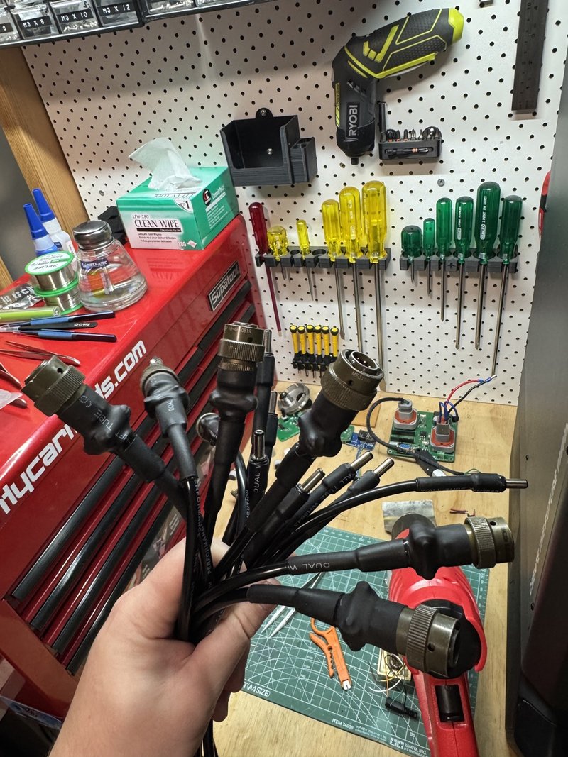 six completed replacement connector harnesses on a workshop bench